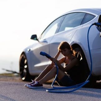 Customer with electric vehicle, stranded on the road with a dead battery. Ace Battery Express emergency mobile EV charging services